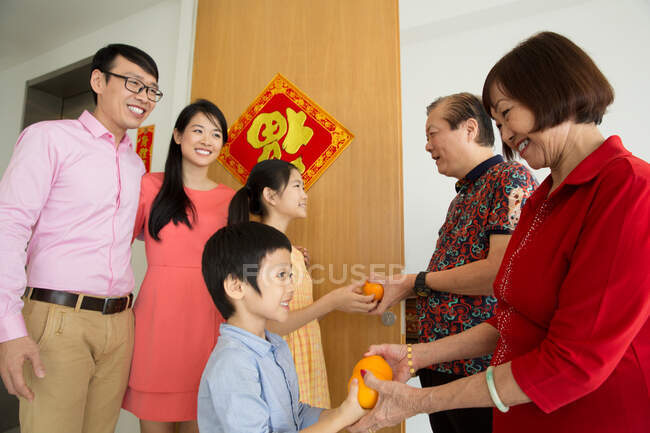 Happy asian family coming to grandparents at chinese new year — Stock Photo