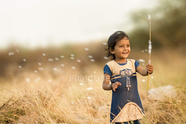 Girl playing with flower. happiness on face. — Stock Photo