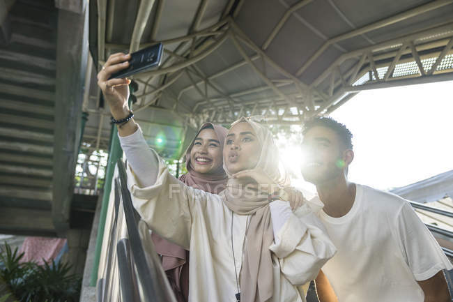 Groupe d'amis musulmans heureux prenant selfie sur smartphone — Photo de stock