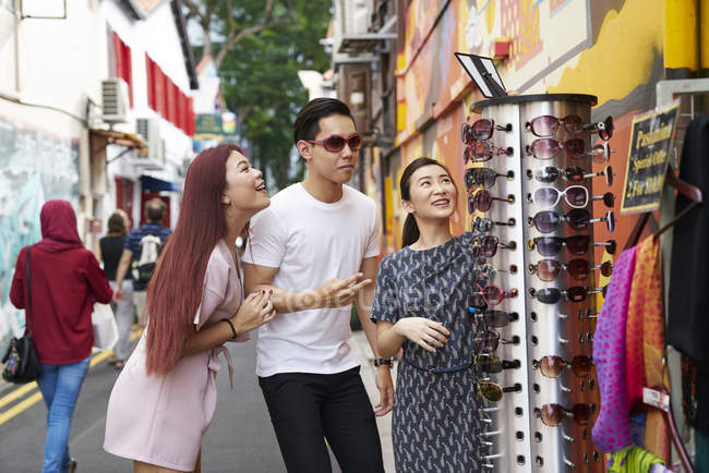 Jovem feliz asiático amigos passando tempo juntos em Cingapura e tomando óculos — Fotografia de Stock