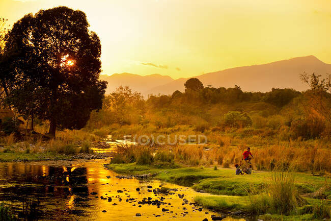 A town in Abra, Philippines,  three children play on this beautiful landscape. — Stock Photo