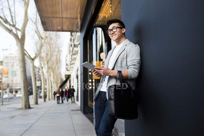 Uomo d'affari cinese in piedi accanto a un negozio di lusso in Serrano Street, Madrid, Spagna — Foto stock