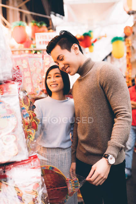 Happy asian couple celebrating Chinese New Year in city — Stock Photo