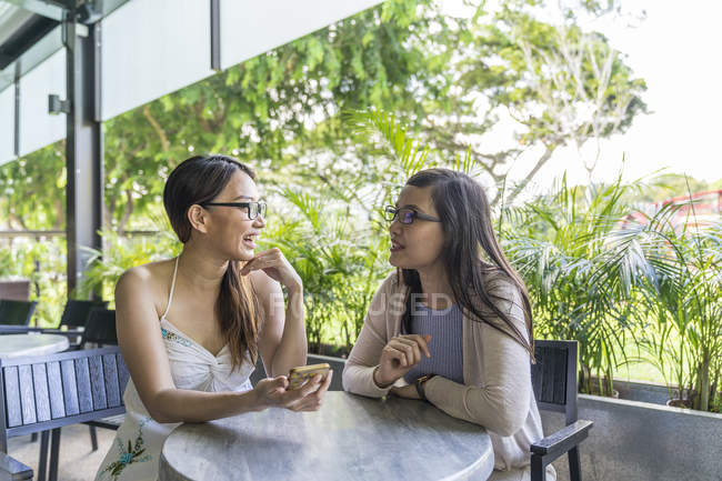 Young attractive asian women using smartphone — Stock Photo