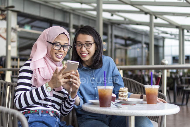 Две дамы наслаждаются своим временем в кафе — стоковое фото
