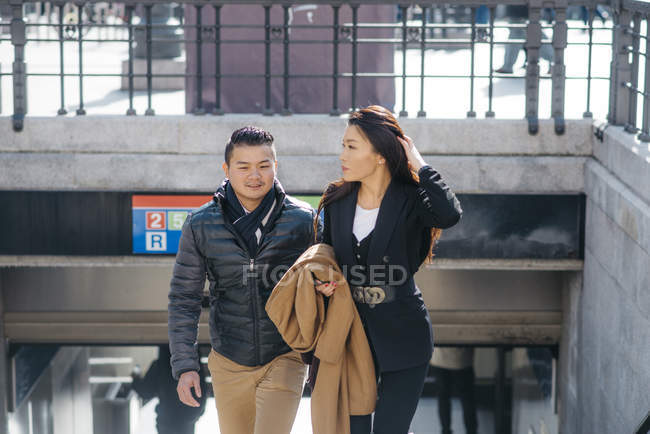 Chinese couple walking up a flight of stairs, Spain — Stock Photo