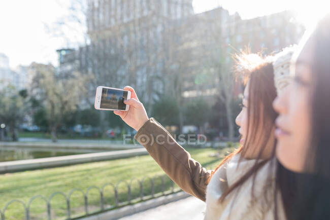 Asian women doing tourism in Madrid and taking a picture — Stock Photo