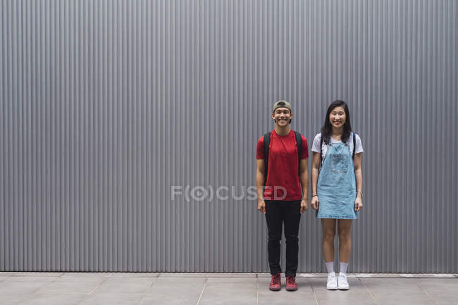 Junge asiatische College-Studenten posieren gegen Wand — Stockfoto
