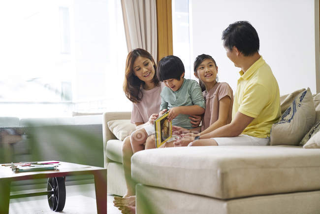 Family bonding over a book reading session at home — Stock Photo