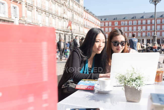 Азиатки в кафе с ноутбуком в Мадриде, Испания — стоковое фото