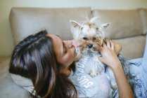 Woman lying with Yorkshire Terrier — Stock Photo
