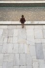 Woman standing on tiled floor — Stock Photo