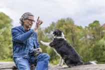 Man teaching dog — Stock Photo