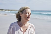 Frau steht am Strand — Stockfoto