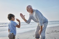 Grandfather and grandson high fiving — Stock Photo