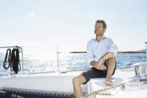 Man sitting on sailing boat — Stock Photo