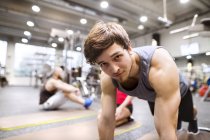 Young man exercising in gym — Stock Photo