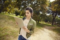 Young woman in nature with tablet — Stock Photo