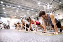 Athletes exercising in gym — Stock Photo