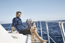 Relaxed man sitting on yacht — Stock Photo