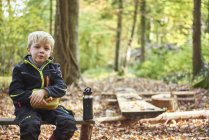 Little boy having lunch in the forest — Stock Photo