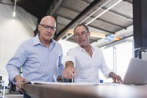 Businessmen discussing plan on table — Stock Photo