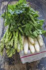 Asparagus and parsley in wire basket — Stock Photo