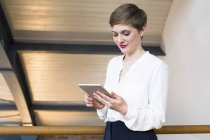 Businesswoman looking at tablet — Stock Photo