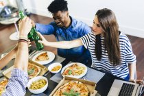 Friends having pizza and beer — Stock Photo