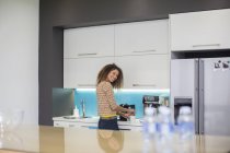 Woman in office kitchen — Stock Photo