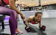Woman with trainer working out — Stock Photo