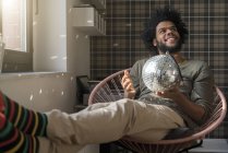 Man holding mirror ball — Stock Photo