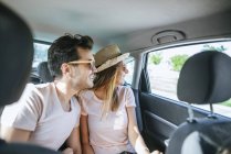 Couple in the back seat of car — Stock Photo