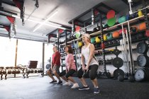 Seniors working out with kettlebells — Stock Photo
