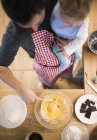 Father and baby boy baking a cake in kitchen — Stock Photo