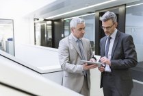 Businessmen using digital tablet — Stock Photo