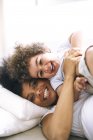 Portrait of mother and little son cuddling in bed — Stock Photo