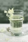 Glass of water flavoured with elderflower sirup — Stock Photo