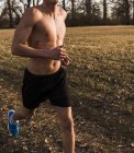 Cropped portrait of young man running in field — Stock Photo