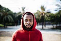Portrait of young black guy in casual clothing, with the hood up. — Stock Photo