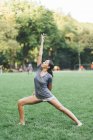 Young attractive african american woman doing stretching at park — Stock Photo