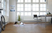 Interior of a modern informal office with bicycle — Stock Photo