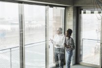 Senior manager discussing documents with young coworker — Stock Photo
