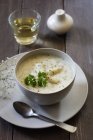 Closeup view of asparagus cream soup with parsley leaf — Stock Photo