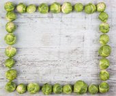 Frame with fresh Brussels sprouts — Stock Photo