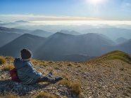 Italy, Marche, Boy watching Apennines at sunset — Stock Photo
