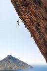 Ritratto dell'arrampicatore maschio appeso alla corda vicino alla parete rocciosa — Foto stock