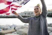 Young woman with waving american flag — Stock Photo