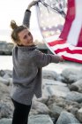 Girl with american flag by the seashore — Stock Photo