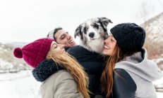 Léon, Espagne, trois amis s'amusent avec leur chien dans la neige — Photo de stock